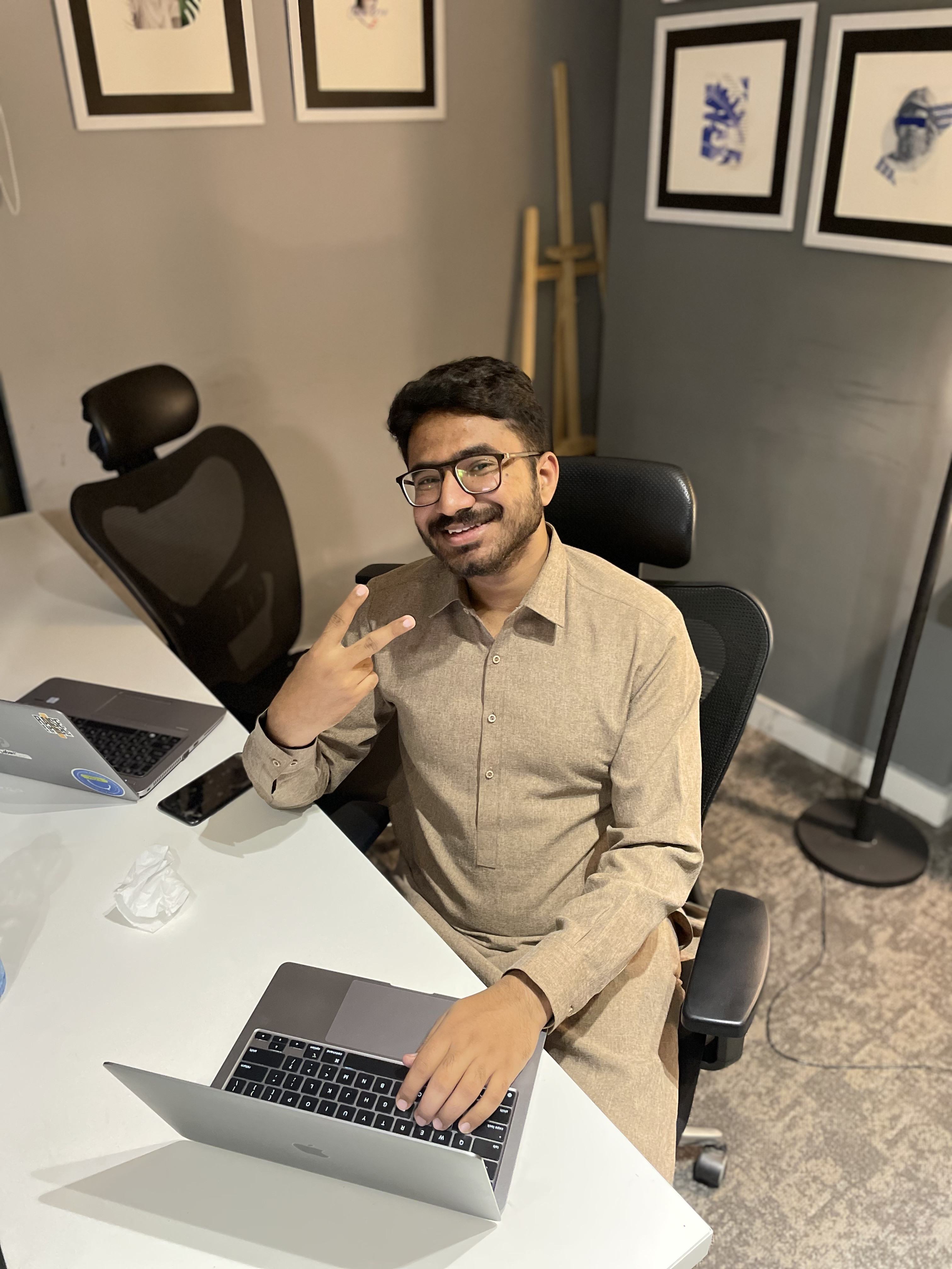 Hamza Shabbir at his product design workspace Hamza Shabbir (UXHAMZA), product designer working at his desk in Figma